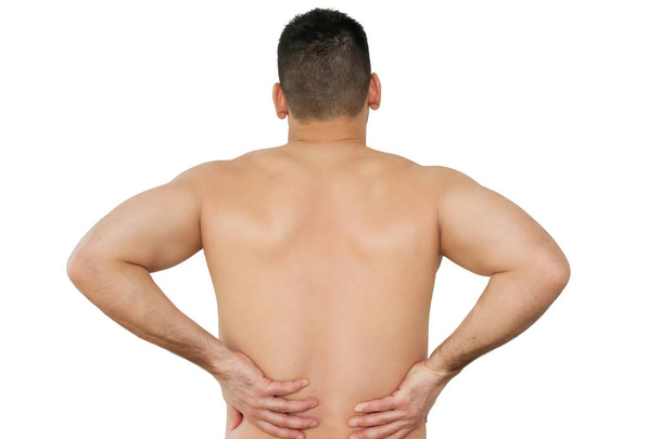 Studioaufnahme eines jungen Mannes mit Rückenschmerzen - Foto, Bild