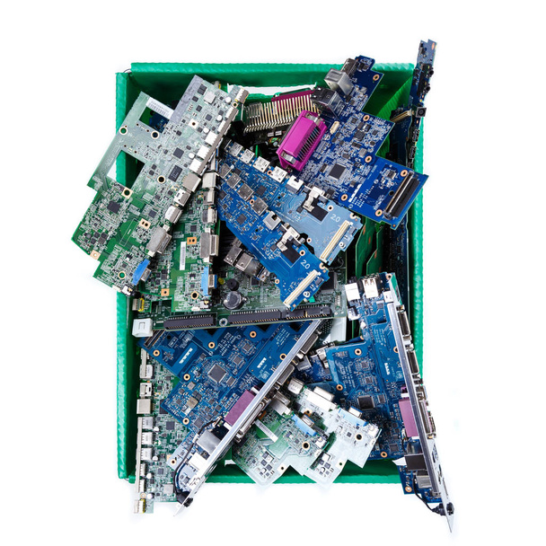 Computer parts ready for recycling on white background  (Motherboard main board computer hardware in green recycle bin) - Photo, Image