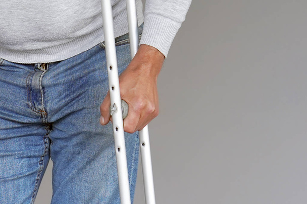 Man with crutch. Close-up. Front view - Photo, Image