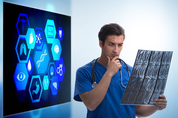 Doctor in telemedicine concept looking at x-ray image - Photo, Image