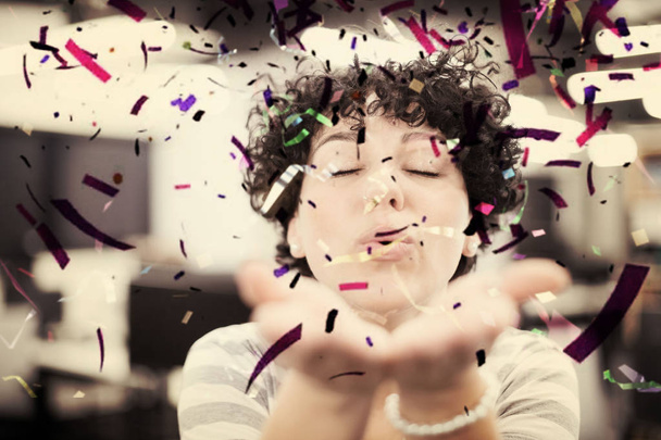 female software developer blowing confetti - Foto, Imagem