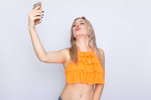 Blonde woman making selfie - 写真・画像