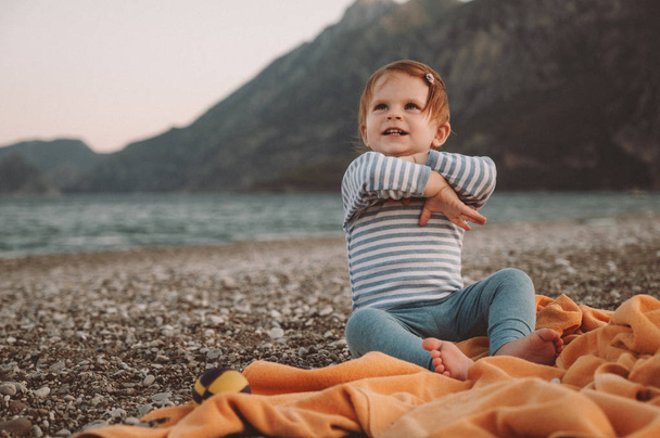 Cute little baby girl playing on a beach in summer day. Family Travel and vacation concept - Valokuva, kuva