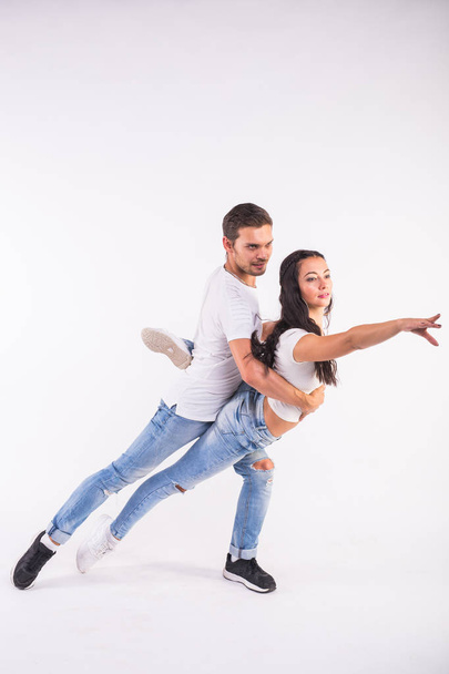 Passionate couple dancing social danse kizomba or bachata or semba or taraxia on white background - Zdjęcie, obraz