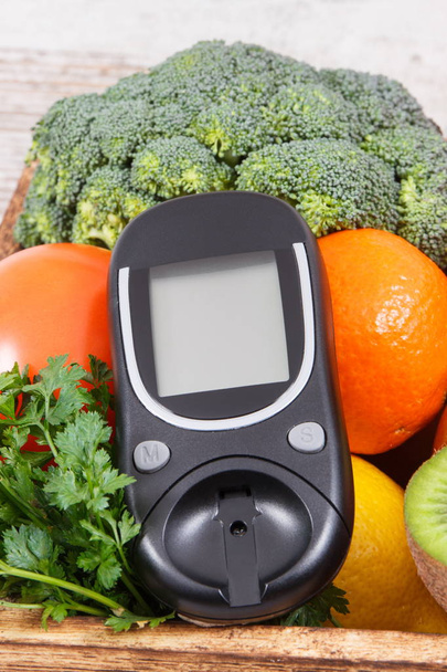 Glucometer and natural fruits with vegetables. Diabetes and nutritious food containing minerals and vitamins - Photo, image