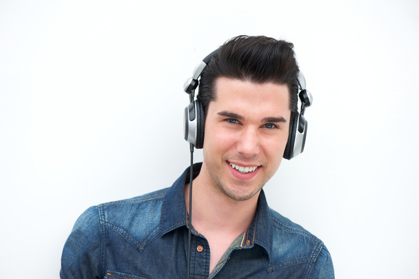 Happy young man listening to music and smiling - Foto, Imagem