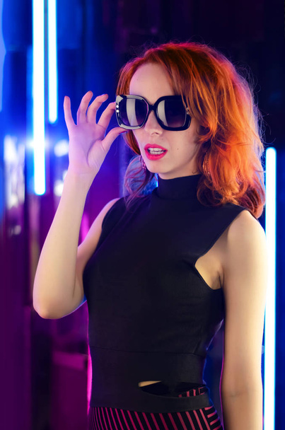 The girl in the glasses neon light. Girl with lush red hair - Foto, Imagem