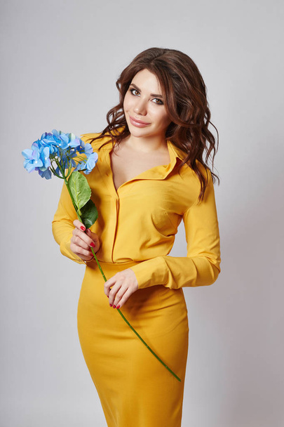 Bright spring portrait of a woman in a yellow skirt and blouse.  - Foto, Imagem