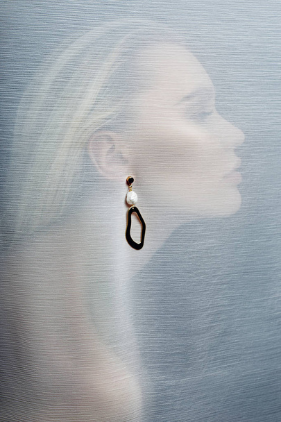 Earrings and jewelry in the ear of a sexy woman inserted through - Fotoğraf, Görsel