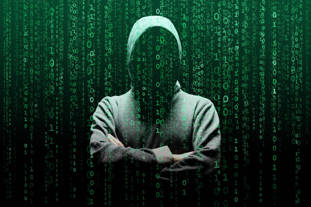 Computer hacker in mask and hoodie over abstract binary background. Obscured dark face. Data thief, internet fraud, darknet and cyber security concept. - Fotografie, Obrázek
