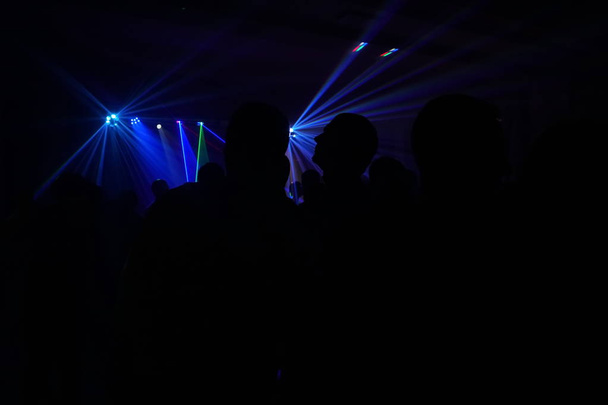 Crowd of people dancing under disco laser light - Photo, Image