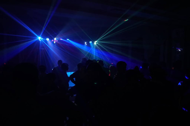 ディスコ レーザー光の下で踊る人々 の群衆 - 写真・画像