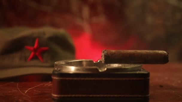 Close up of a Cuban cigar and ashtray on the wooden table. Communist dictator commander table in dark room. Army general`s work table concept. Artwork decoration - Footage, Video