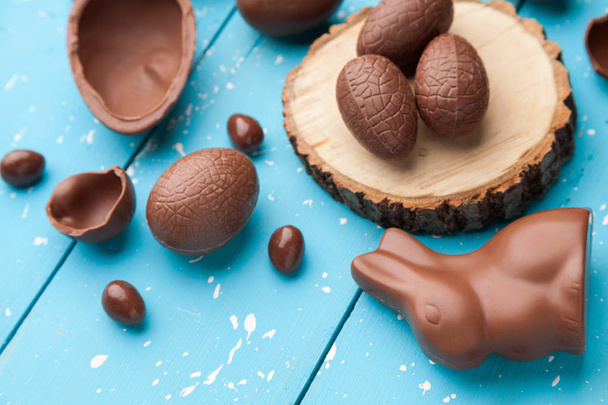 Chocolate Easter bunny, eggs and sweets on rustic background - Фото, зображення