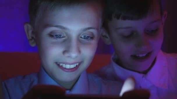 Two cute boys playing video game with smart phone indoors - Footage, Video