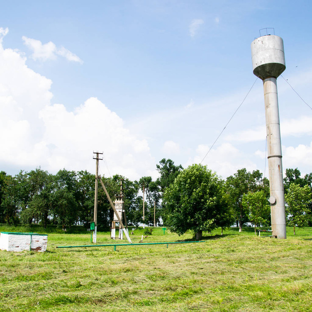 Silver Water Tower among green - Photo, Image