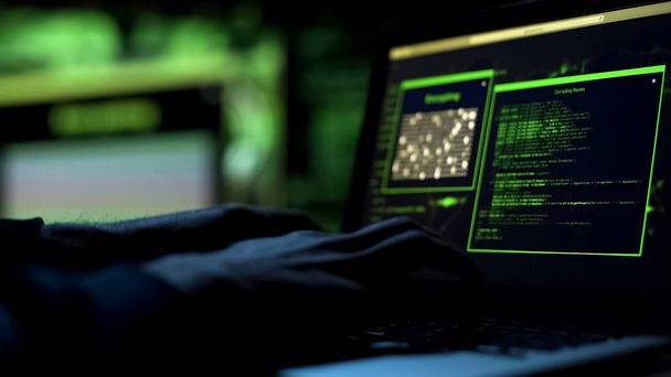 Hacker working on creating malicious software, typing on laptop keypad, closeup - Фото, зображення