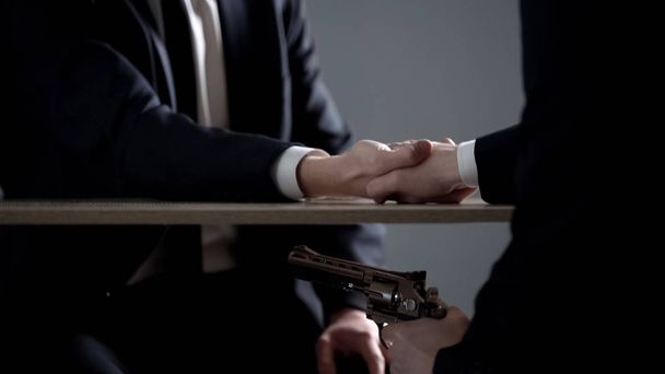 Businessman under death threat by gun blackmail, unprofitable deal agreement - Valokuva, kuva