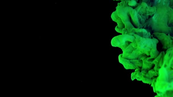 Ink in water. Green neon with glitter particles paint reacting in water creating abstract cloud formations. Can be used as transitions,added to modern projects,art backgrounds, anything with creative - Footage, Video