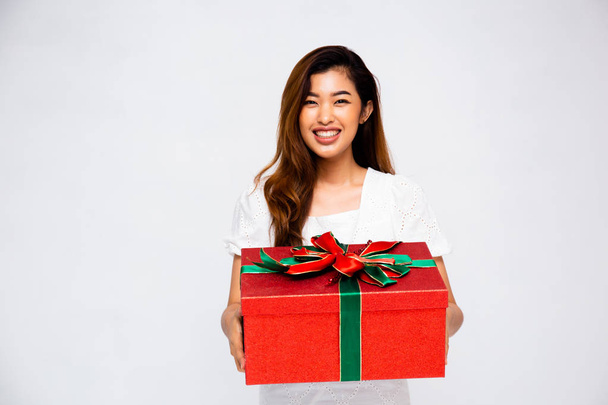 Cheerful Asian woman with present - Фото, зображення