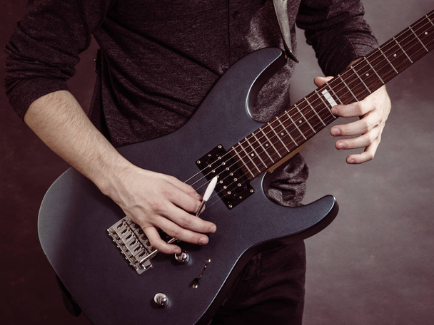 Male hands playing electric guitar - 写真・画像