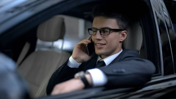 Successful businessman talking on phone with boss as sitting in car, good news - Fotoğraf, Görsel