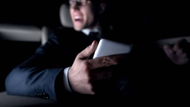 Furious man shouting in car, got message about failed contract, work problems - Fotó, kép