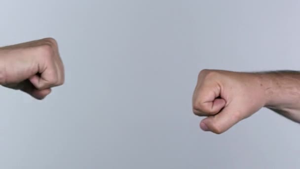 Two men fist bumping and hand shaking over white screen. - Video