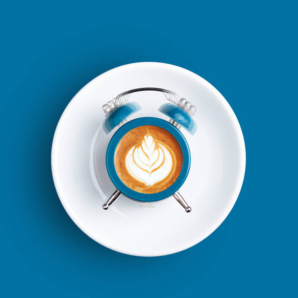 Clock with the dial of coffee on blue background. - Photo, Image