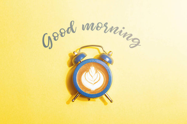 Clock with the dial of coffee on yellow background. - Photo, Image