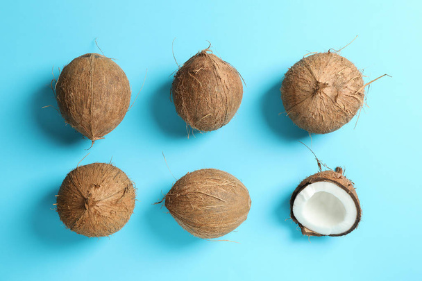 Flat lay composition with coconuts on color background - Φωτογραφία, εικόνα