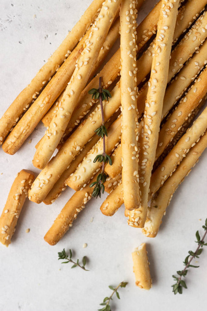 Italian grissini or salted bread sticks on a light stone background. Fresh italian snack. Copy space.  - Photo, Image