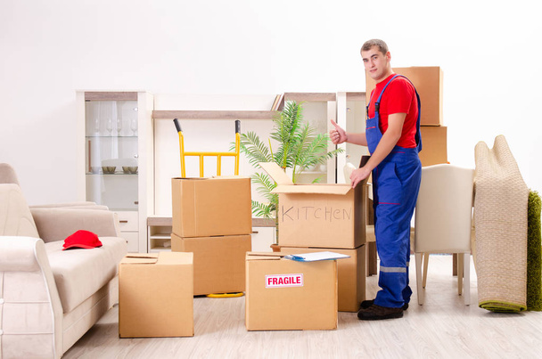 Young contractor with boxes working indoors  - Photo, Image