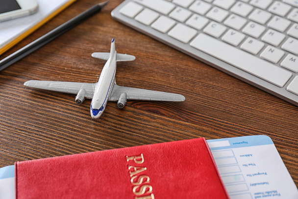 Composition with airplane model on wooden table. Travel agency concept - Foto, immagini