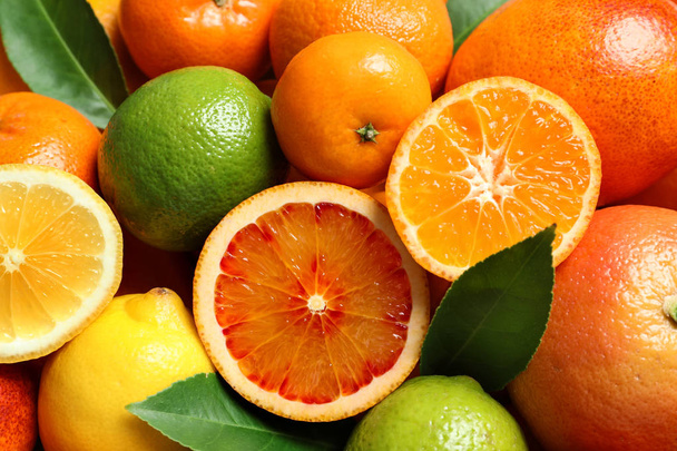 Different citrus fruits as background, top view - Фото, зображення