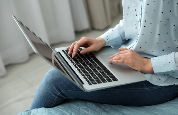 Blogger working with modern laptop at home, closeup - Zdjęcie, obraz
