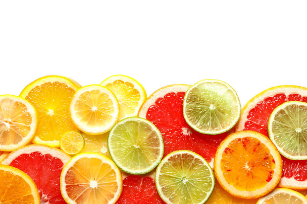 Slices of fresh citrus fruits on white background, top view - Foto, Imagen