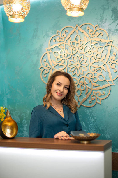 Beautiful woman at reception desk in yoga and wellness center - Photo, Image
