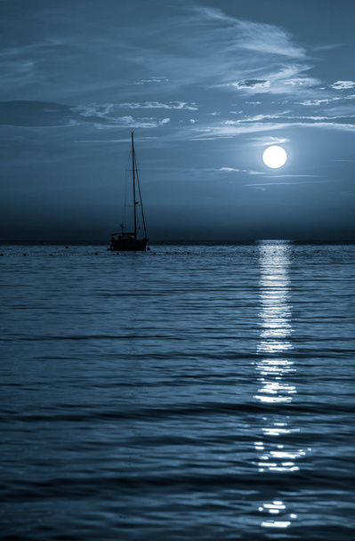 Beautiful night Adriatic sea, yacht and full moon, Croatia. Night seascape. - Photo, Image