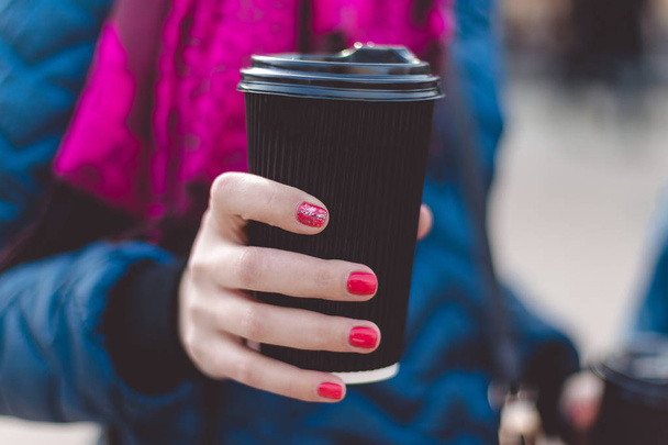 Close up of women hands holding paper cup of coffee - Photo, image