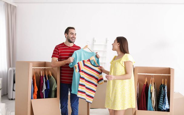 Young couple near wardrobe boxes at home - Photo, image