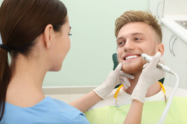 Professional dentist working with patient in modern clinic. Teeth care - Photo, Image