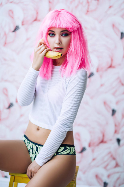 Fashion photoshoot of the attractive European woman with pink hair and bright colorful makeup, stylish woman with pink hair, colorful makeup for active women - Foto, Bild