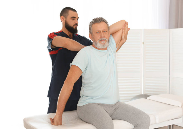 Physiotherapist working with patient in clinic. Rehabilitation therapy - Foto, immagini