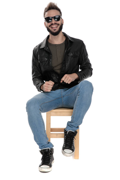 man in black jacket and blue jeans laughing  - Photo, image