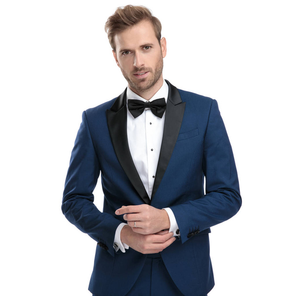 married man in blue suit adjusting his sleeve - Photo, Image
