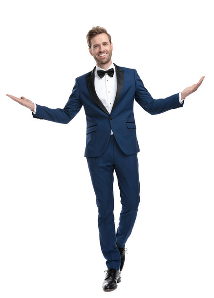 positive guy in blue suit greeting with hands - Foto, immagini