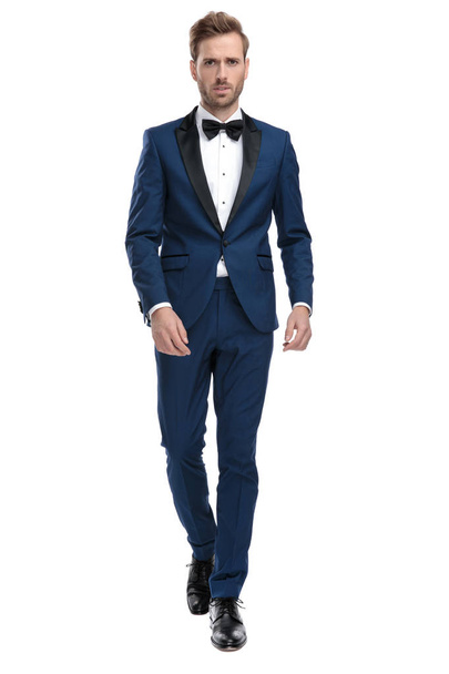 serious man in blue tuxedo walking - Фото, изображение
