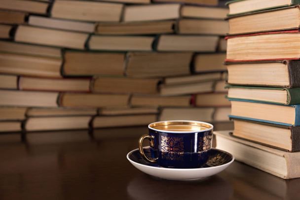 cup of tea on the background of books - 写真・画像