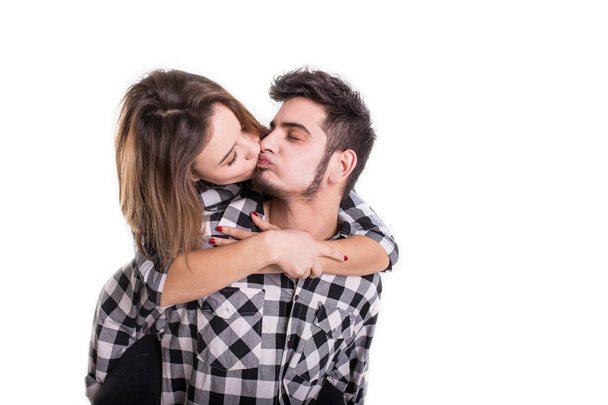 Happy young couple embracing each other and kissing isolated on  - Фото, изображение